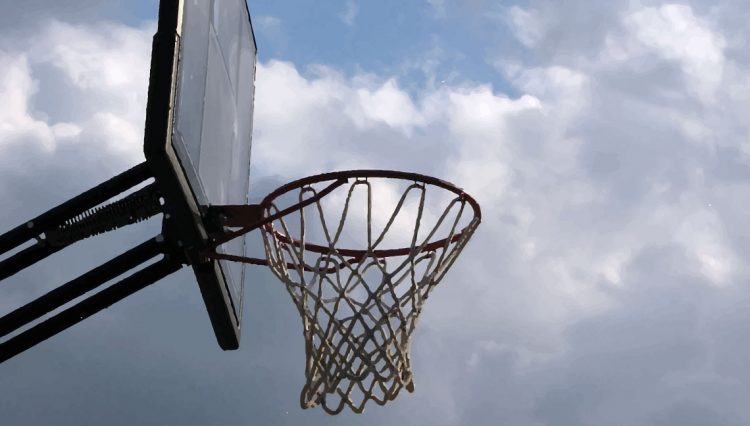 A basketball net in cloudy sunshine.