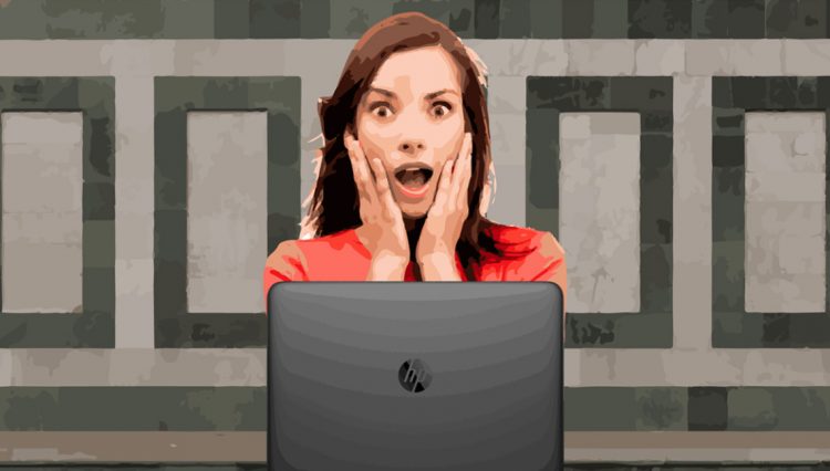 Surprised woman in front of computer